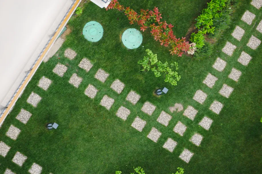 An aerial shot of a backyard with paving stones that form a pathway.