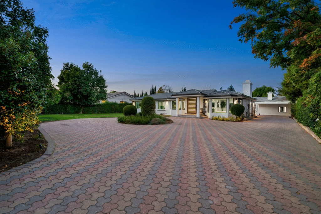 Elegant suburban home featuring a freshly paved, colorful driveway.