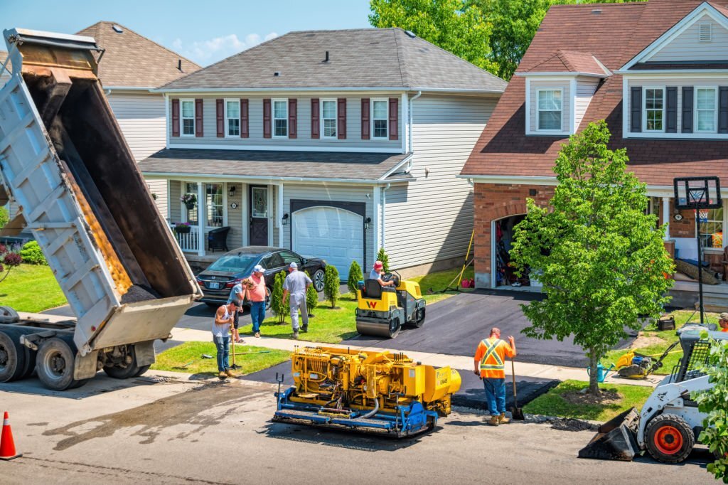 Workers work during driveway paving in Boston
